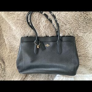 Pebbled black leather coach handbag.